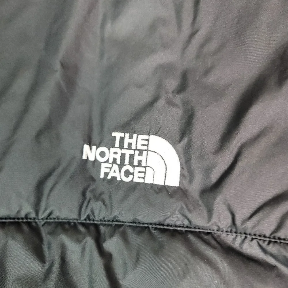 Premium insulated puffer vest by The North Face featuring embroidered Synchrony